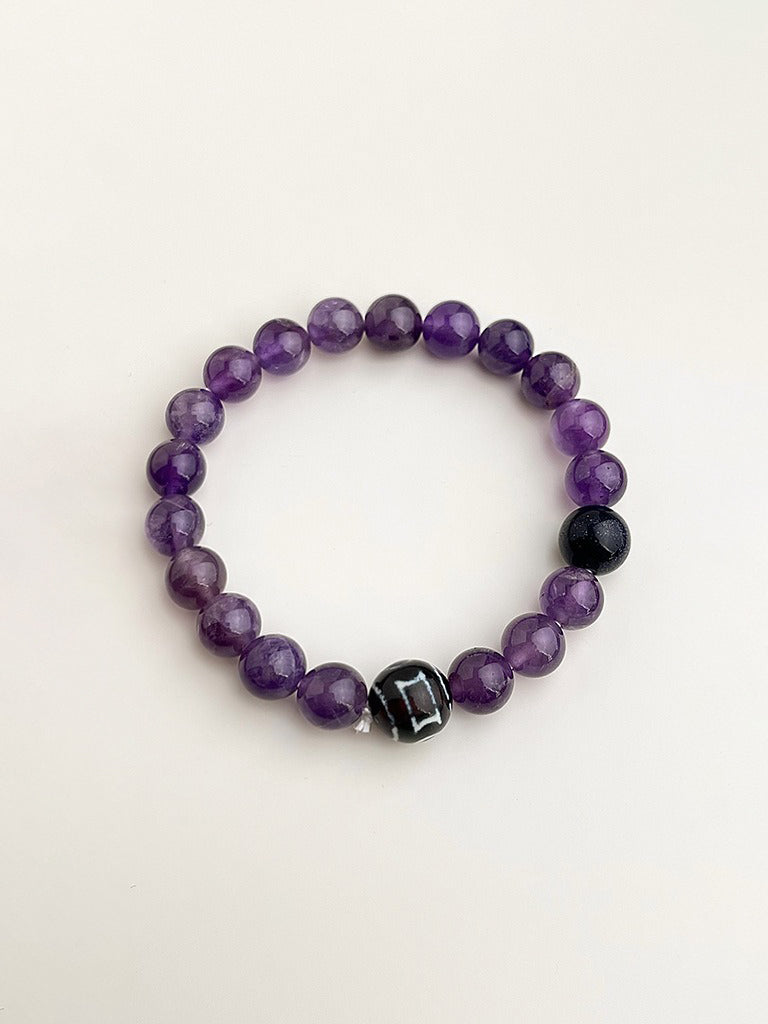 Amethyst and black natural stone bracelet with soft purple tones