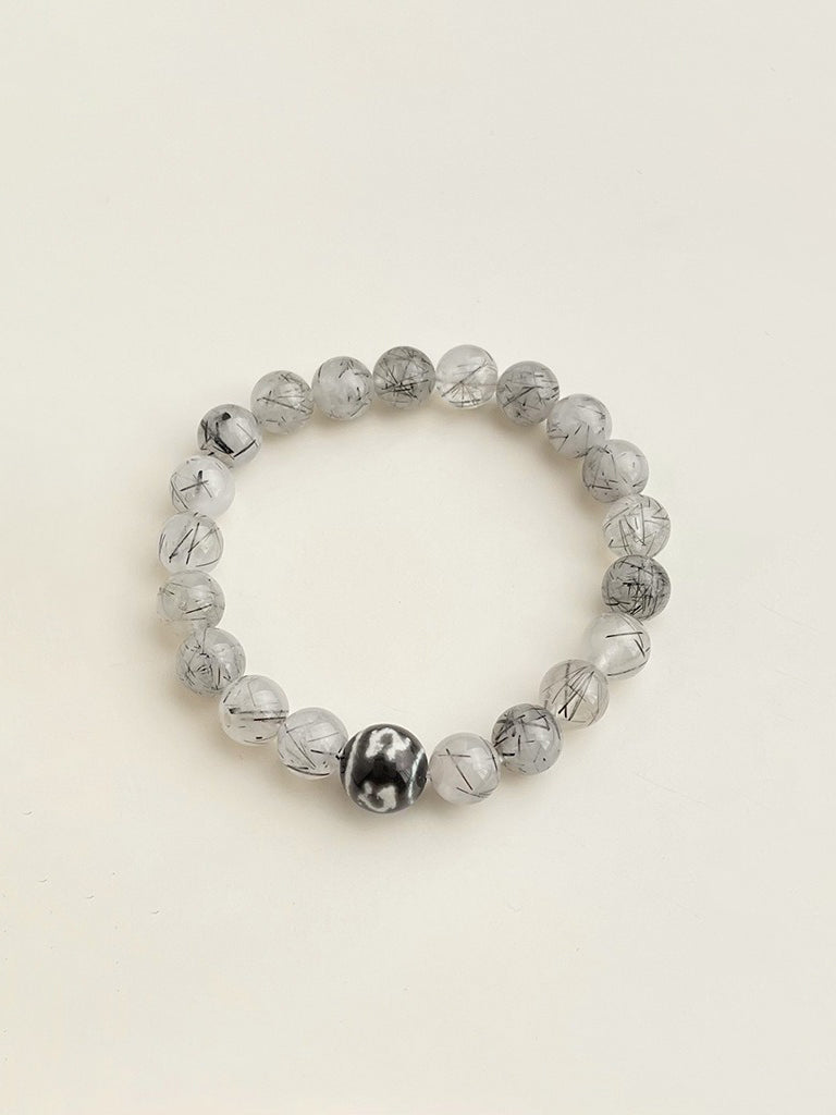 Black rutilated quartz crystal bracelet with transparent stones and dark inclusions