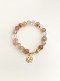 Red rutilated quartz bracelet with gold tag detail
