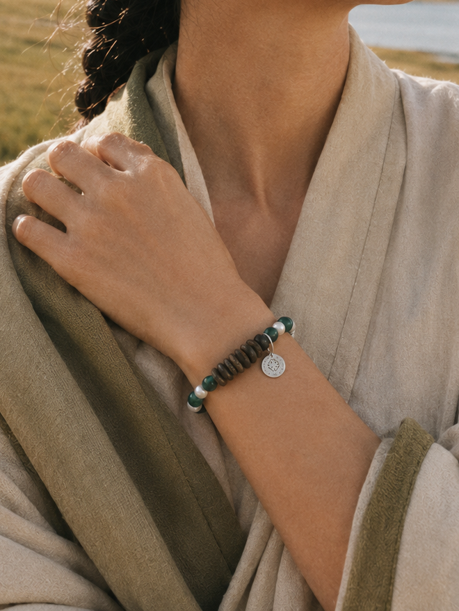 Malachite agarwood bracelet lifestyle image with natural green and wood tones