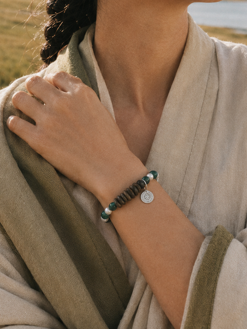 Malachite agarwood bracelet lifestyle image with natural green and wood tones