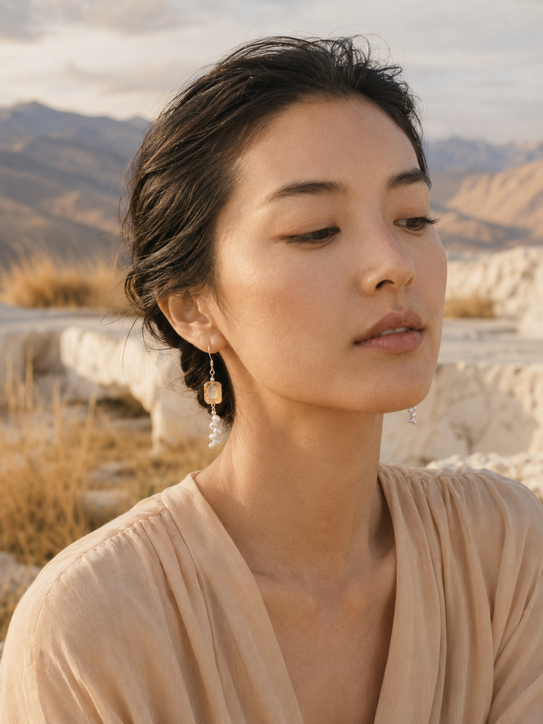 Citrine pearl silver earrings lifestyle image with soft warm tones