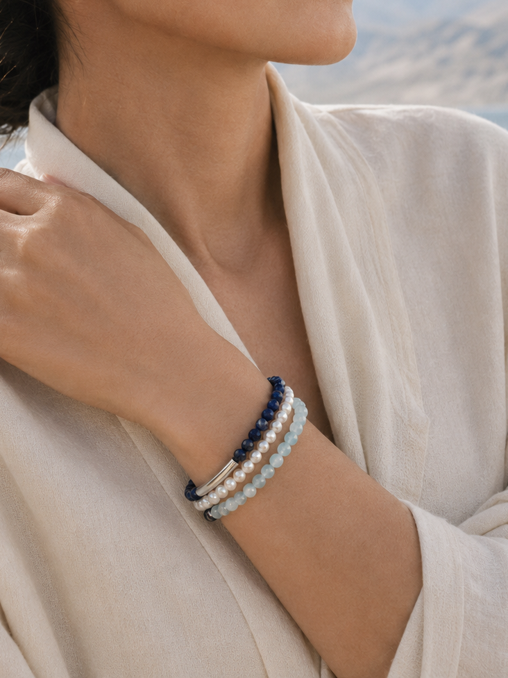 Aquamarine lapis pearl wrap bracelet lifestyle image with soft blue tones