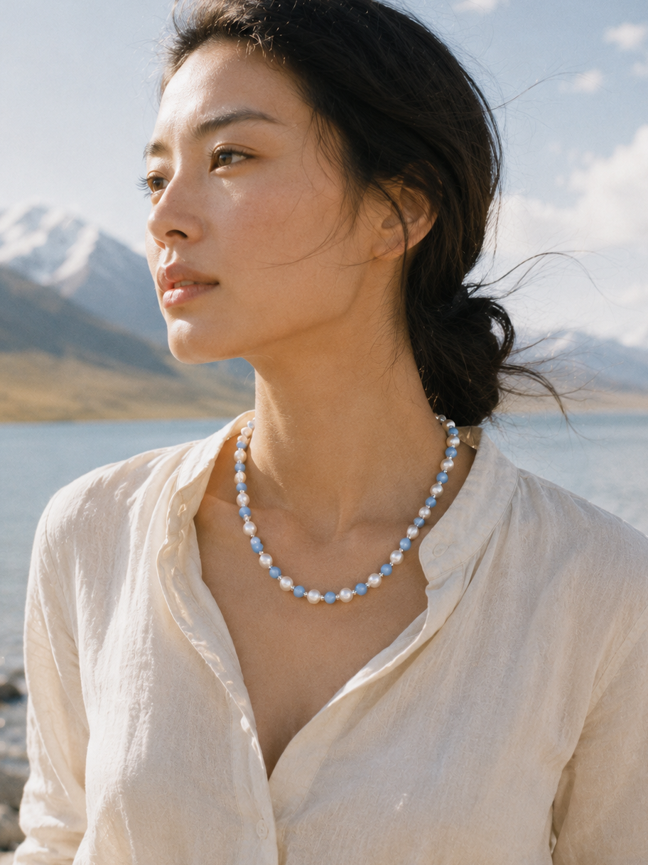 Blue pearl beaded necklace lifestyle image with soft summer tones